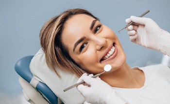 a woman receiving her dental implant restoration(s) in Goodyear
